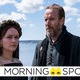 Olivia Cooke as Alicent Hightower and Rhys Ifans as Otto Hightower in their medieval inspired House of the Dragon looks stand on a rocky shore in front of the ocean.